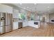 Spacious, open-concept kitchen featuring white cabinets, stainless steel appliances, and an island with a built-in microwave at 1506 Camino Summit Ave, Henderson, NV 89012