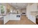 Bright, open kitchen featuring white cabinets, stainless steel appliances, island, and modern lighting at 1506 Camino Summit Ave, Henderson, NV 89012