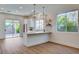 Bright, stylish kitchen featuring a breakfast bar, tile backsplash, and seamless access to the outdoor patio at 1506 Camino Summit Ave, Henderson, NV 89012