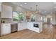 Bright kitchen showcasing white cabinets, stainless steel appliances, an island, and modern pendant lighting at 1506 Camino Summit Ave, Henderson, NV 89012