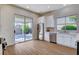 Bright kitchen featuring stainless steel appliances, white cabinetry, and sliding glass door to the outdoor patio at 1506 Camino Summit Ave, Henderson, NV 89012