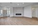 Bright and airy living room featuring a contemporary fireplace, neutral walls, and wood-look flooring at 1506 Camino Summit Ave, Henderson, NV 89012