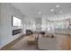 Open-concept living room showcasing a fireplace, modern décor, and seamless flow into the kitchen area at 1506 Camino Summit Ave, Henderson, NV 89012