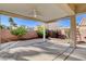 Relaxing covered patio area with a ceiling fan and garden view at 1506 Camino Summit Ave, Henderson, NV 89012