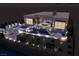 Night aerial view of a modern home, showcasing an outdoor pool, dining area, and lounge areas at 1596 Pleasant Bay Ct, Henderson, NV 89011