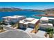 Stunning aerial view of modern homes on a waterfront property with beautiful lake and mountain views at 1596 Pleasant Bay Ct, Henderson, NV 89011