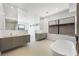 Bright bathroom featuring double vanities and a modern soaking tub at 1596 Pleasant Bay Ct, Henderson, NV 89011