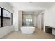 Modern bathroom with a freestanding tub and a glass-enclosed shower at 1596 Pleasant Bay Ct, Henderson, NV 89011