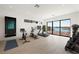 Exercise room with water view, treadmill, peloton, free weights, and tonal machine at 1596 Pleasant Bay Ct, Henderson, NV 89011