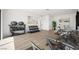 An inviting exercise room with modern equipment, a desk, art, plants and wood floor at 1596 Pleasant Bay Ct, Henderson, NV 89011