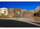 Modern home exterior with neutral tones, desert landscaping, multi car garage and clean architectural lines at 1596 Pleasant Bay Ct, Henderson, NV 89011