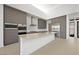 A modern kitchen with gray cabinets, stainless steel appliances, a center island, and an eat-in countertop at 1596 Pleasant Bay Ct, Henderson, NV 89011