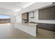 Modern kitchen with large island, stainless appliances, and view of the lake at 1596 Pleasant Bay Ct, Henderson, NV 89011