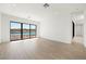 Bright, open living room with water view from the floor to ceiling windows at 1596 Pleasant Bay Ct, Henderson, NV 89011