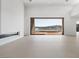 Bright open living area with neutral colors, a modern fireplace, and views of the water at 1596 Pleasant Bay Ct, Henderson, NV 89011