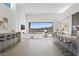 Beautiful bright open concept living space with kitchen bar and seating with a view of the water and mountains at 1596 Pleasant Bay Ct, Henderson, NV 89011