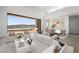 Bright open living space offering modern design and lake views from the sliding glass doors at 1596 Pleasant Bay Ct, Henderson, NV 89011