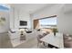 Bright living and dining area, showcasing a modern design and views of the water through sliding glass doors at 1596 Pleasant Bay Ct, Henderson, NV 89011