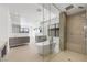 The main bathroom is designed with double shower heads, lake views and a free standing tub at 1596 Pleasant Bay Ct, Henderson, NV 89011
