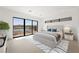 Modern bedroom with neutral decor, plush bedding, and a large window with lake and mountain views at 1596 Pleasant Bay Ct, Henderson, NV 89011