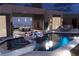 Stunning night view of a luxurious pool and spa area with ambient lighting and desert views at 1596 Pleasant Bay Ct, Henderson, NV 89011