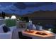 Relaxing outdoor lounge with a fire pit, comfortable seating, and scenic mountain views at 1596 Pleasant Bay Ct, Henderson, NV 89011