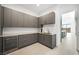 Ample pantry featuring built-in wine storage, gray cabinets, and stone countertops at 1596 Pleasant Bay Ct, Henderson, NV 89011