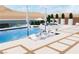 Relaxing poolside with lounge chairs, lush greenery, and desert landscape views at 1596 Pleasant Bay Ct, Henderson, NV 89011