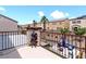 Upper balcony area looking out onto a landscaped backyard with lounge seating and a fire pit at 1604 Patrick Thomas Ct, North Las Vegas, NV 89086