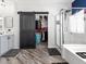 Well-lit bathroom featuring a walk-in closet, shower, tub, and vanity with gray cabinets at 1604 Patrick Thomas Ct, North Las Vegas, NV 89086