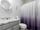 Well-lit bathroom with white marble vanity, modern fixtures, and a stylish shower curtain at 1604 Patrick Thomas Ct, North Las Vegas, NV 89086