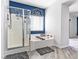 Clean bathroom with a soaking tub and walk-in shower featuring modern fixtures and bright tile at 1604 Patrick Thomas Ct, North Las Vegas, NV 89086