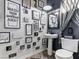 Chic bathroom showcasing decorative wall art, a pedestal sink, and a modern toilet at 1604 Patrick Thomas Ct, North Las Vegas, NV 89086