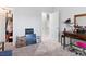 Bedroom with open closet, a makeup vanity with a pink stool, and neutral decor throughout at 1604 Patrick Thomas Ct, North Las Vegas, NV 89086