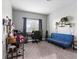 Bedroom features a blue futon, a work desk, decorative shelves and minimalist decor at 1604 Patrick Thomas Ct, North Las Vegas, NV 89086