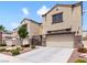 Stunning view of the home's exterior showcasing desert landscaping, covered entry, and two-car garage at 1604 Patrick Thomas Ct, North Las Vegas, NV 89086