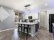 Modern kitchen island with marble countertop, black stools and stainless steel appliances at 1604 Patrick Thomas Ct, North Las Vegas, NV 89086