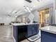 Modern kitchen features center island, granite countertops, stainless steel appliances and luxury vinyl flooring at 1604 Patrick Thomas Ct, North Las Vegas, NV 89086