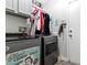 Functional laundry room featuring modern appliances, ample cabinet space, and a convenient layout at 1604 Patrick Thomas Ct, North Las Vegas, NV 89086