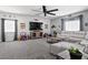 Bright living area featuring comfortable seating, a large TV, and entertainment decor at 1604 Patrick Thomas Ct, North Las Vegas, NV 89086