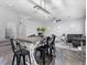 Open concept living space with a wooden dining table and a comfortable gray sofa at 1604 Patrick Thomas Ct, North Las Vegas, NV 89086
