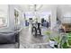 Open-concept living space featuring modern gray sofa and a view of the kitchen at 1604 Patrick Thomas Ct, North Las Vegas, NV 89086