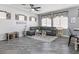 Comfortable living room featuring a plush gray sofa, decorative windows, and stylish decor at 1604 Patrick Thomas Ct, North Las Vegas, NV 89086