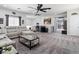Open-concept living room with neutral color palette, plush sofa, and stylish decor throughout at 1604 Patrick Thomas Ct, North Las Vegas, NV 89086