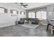 Comfortable living room featuring a plush gray sofa, decorative windows, and stylish decor at 1604 Patrick Thomas Ct, North Las Vegas, NV 89086