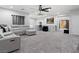 Large open loft with a gray sectional, sleek decor, and modern lighting at 1604 Patrick Thomas Ct, North Las Vegas, NV 89086