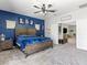 Inviting bedroom with a blue accent wall, a spacious layout, and stylish furnishings at 1604 Patrick Thomas Ct, North Las Vegas, NV 89086