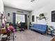 Comfortable office space with a blue futon, desk area, and natural light from the window at 1604 Patrick Thomas Ct, North Las Vegas, NV 89086