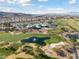 Sun City MacDonald Ranch aerial view with golf course, lush greenery and pond at 2029 Poppywood Ave, Henderson, NV 89012