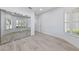 Bright bedroom featuring mirrored closet doors, plantation shutters, and wood-look floors at 2029 Poppywood Ave, Henderson, NV 89012